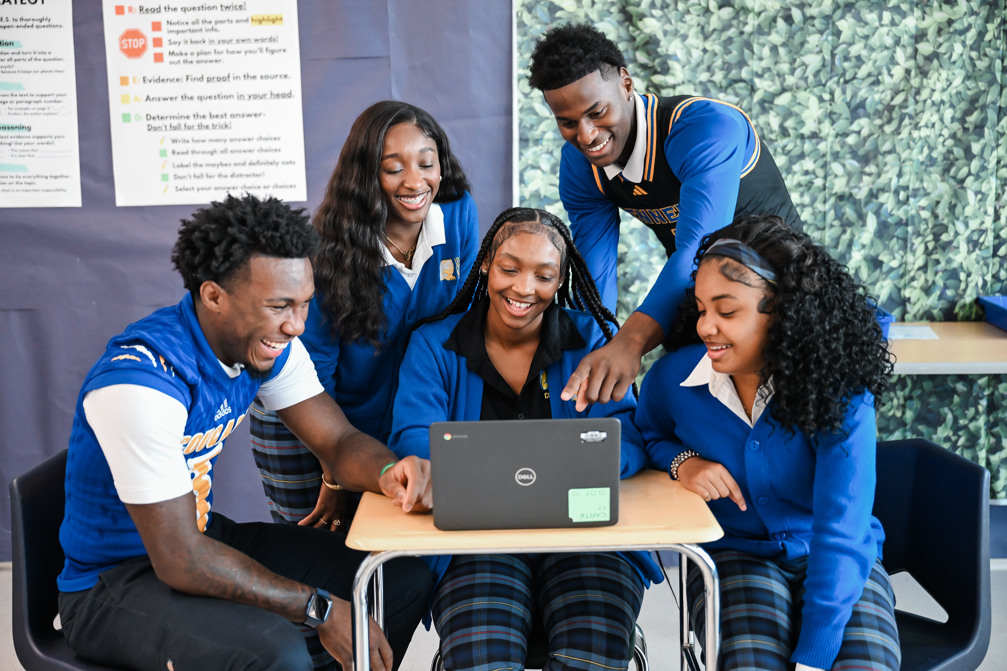 John F. Kennedy High School students working together on a laptop